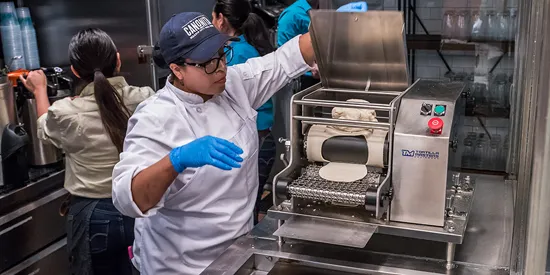 Chef making tortillas in restaurant kitchen