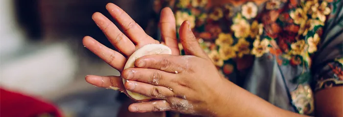 Woman's hands making tortilla