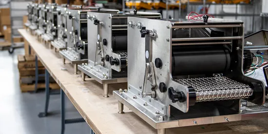 Line of corn tortillas machines in warehouse